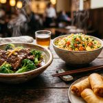Colorful Chinese takeout dishes including beef with broccoli, fried rice, and spring rolls on a restaurant table