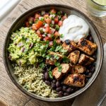Chipotle burrito bowl with seasoned rice, black beans, grilled chicken, guacamole and pico de gallo